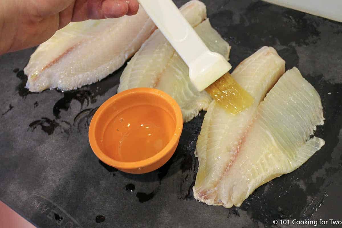 brusing tilapia with oil.