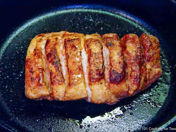 cooked country style ribs in skillet.