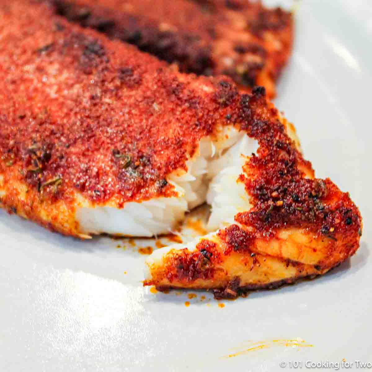 flaky tilapia on plate.