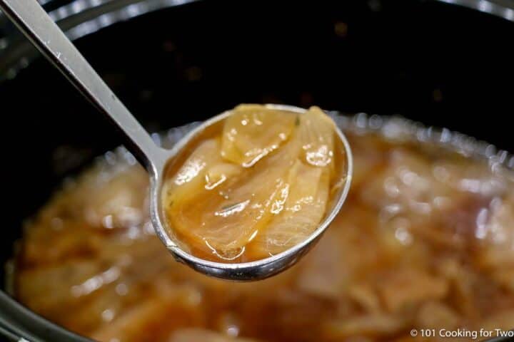 onion soup in a ladle.