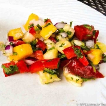 pineapple mango salsa on white plate.