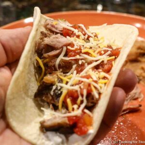 pork carnitas soft taco with toppings.