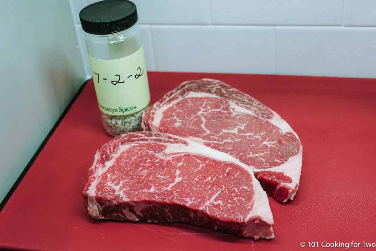 ribeye steaks with seasoning.