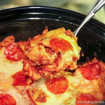 Crock pot pizza casserole in a slow cooker with cheese and pepperoni topping.
