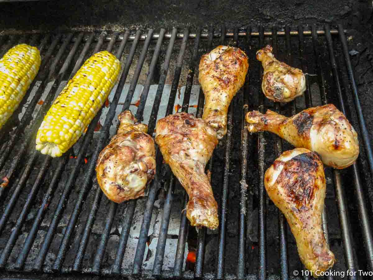 chicken drumsticks cooking on the grill..