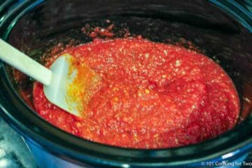 mixing sauce in the crock pot.