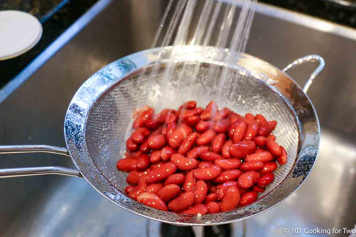 rinsing beans under running water.