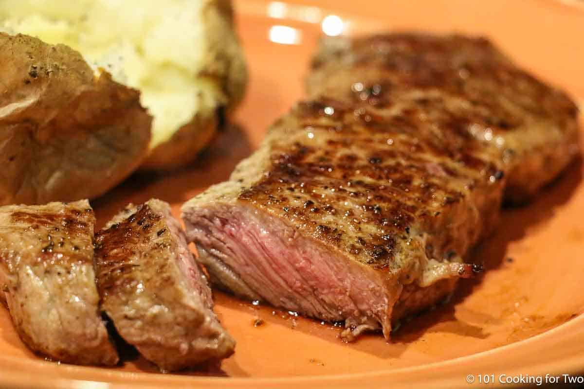 strip steak with baked potato.