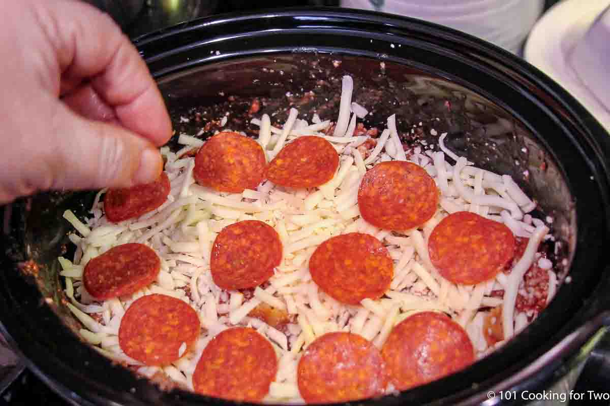 topping a casserole in the crock pot.