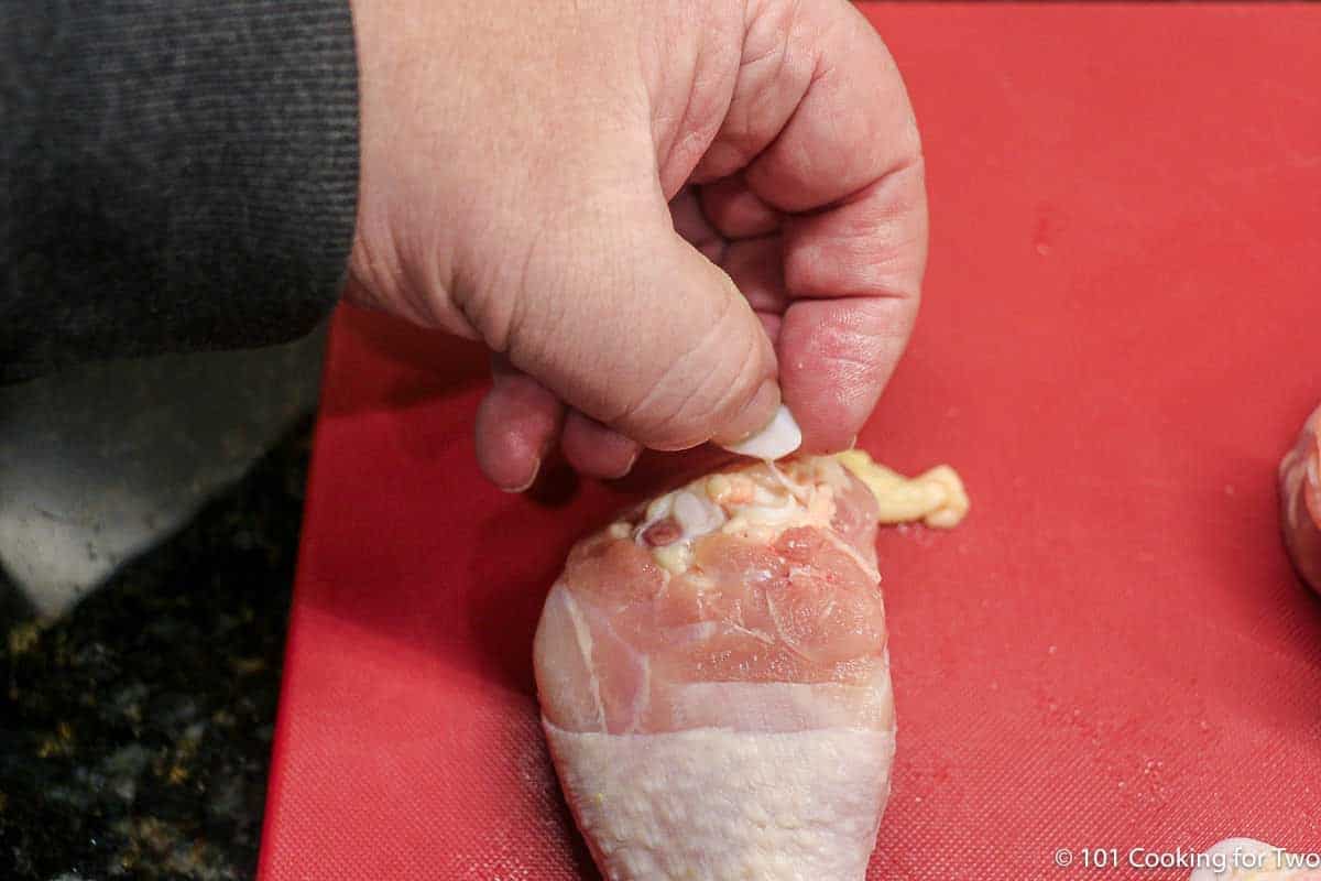 trimming chicken drumstick.
