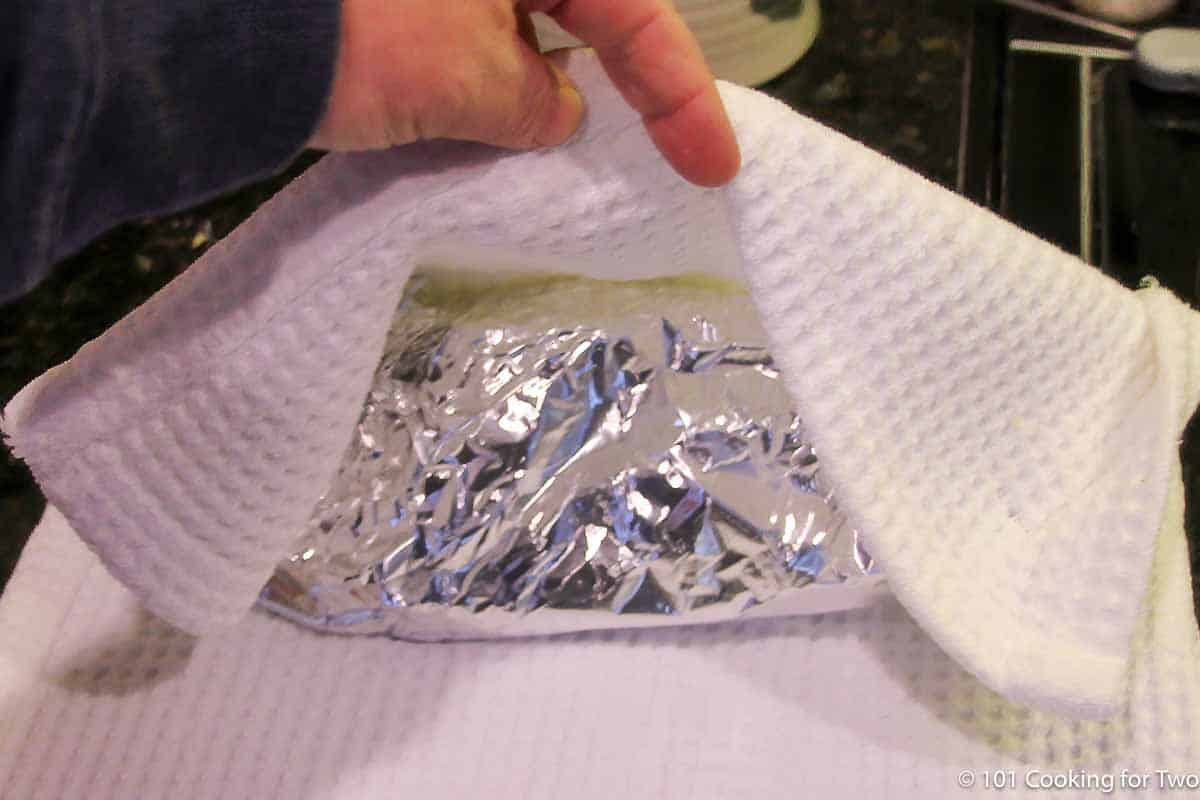 wrap pork butt in aluminum foil then a towel.