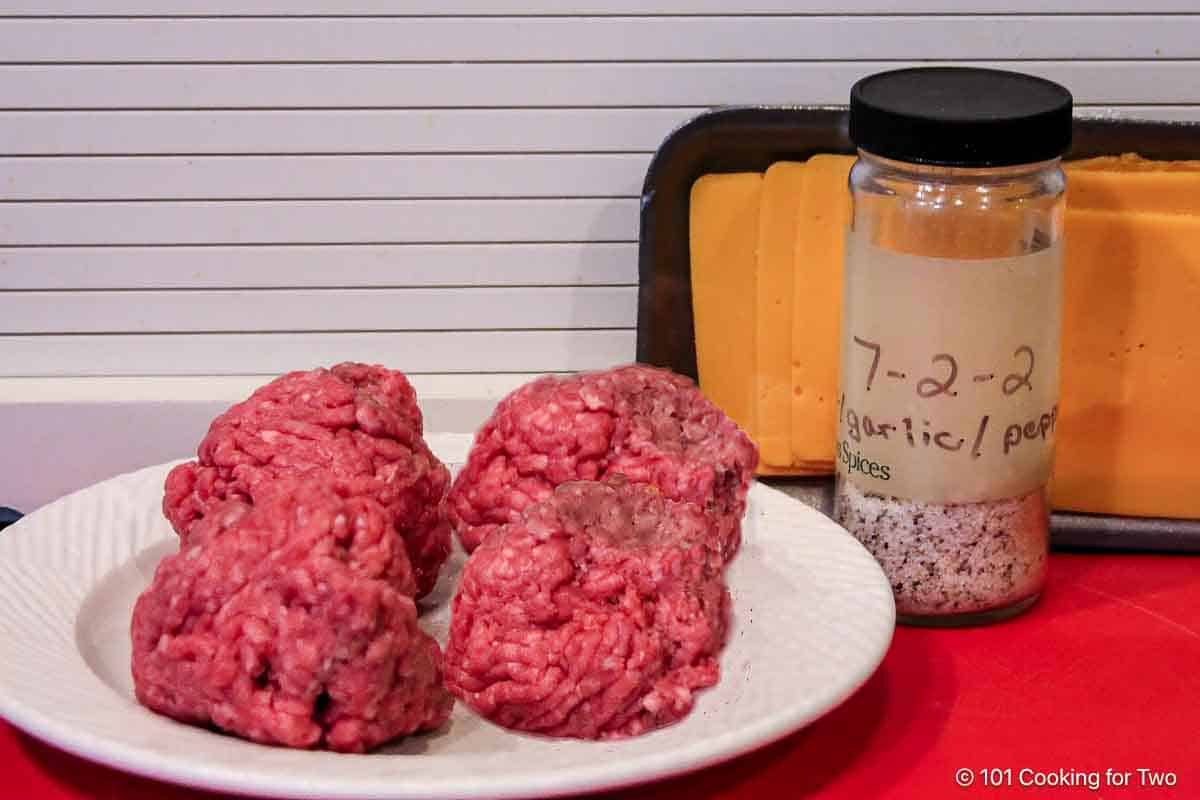 Balls of burger with seasoning and cheese.