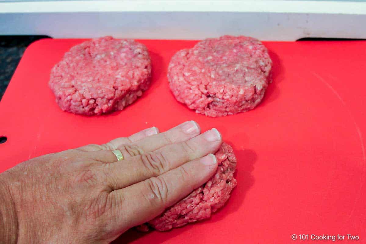 forming hamburger into patties.