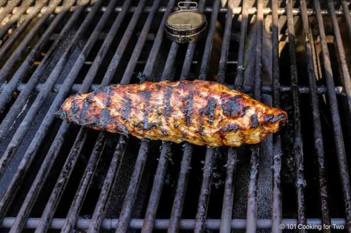 grilled pork tenderloin still on the grill.