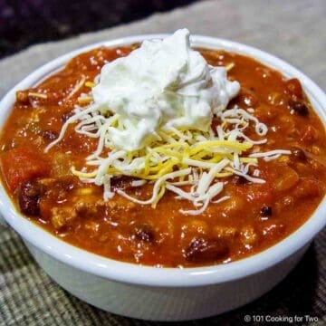 Bowl of taco soup with toppings.