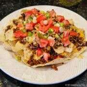 A plate full of ground beef nachos.