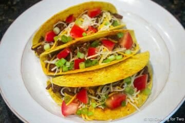 Three hard shell spicy tacos.