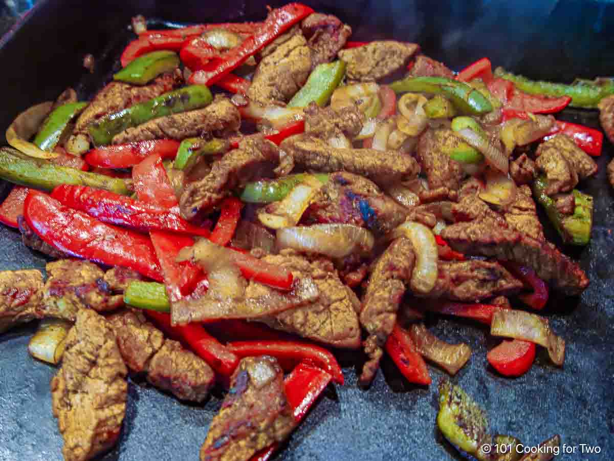 Grilled pork for fajitas on the grill.