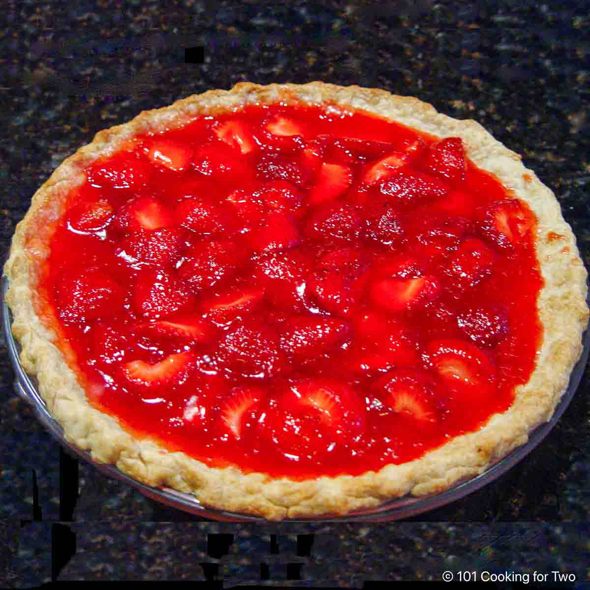 Whole fresh strawberry jello pie ready to eat.