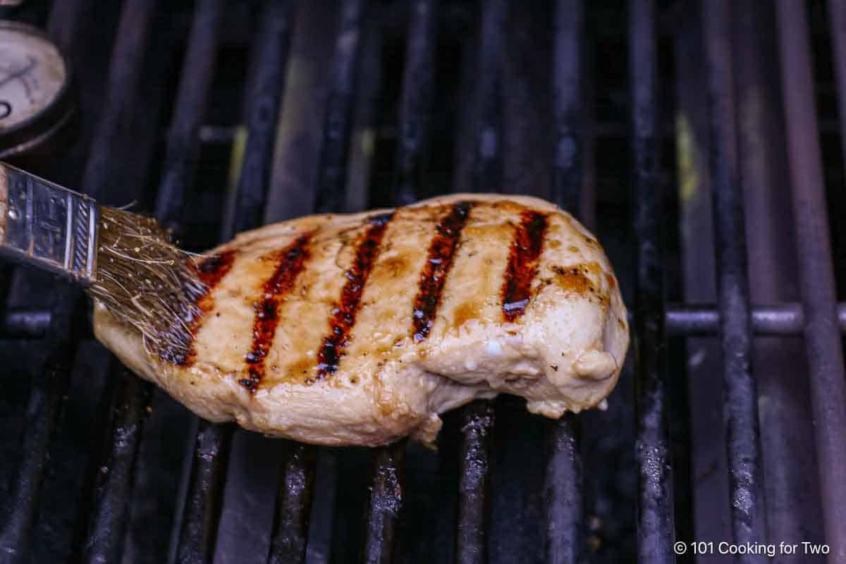 brushing glaze on chicken.