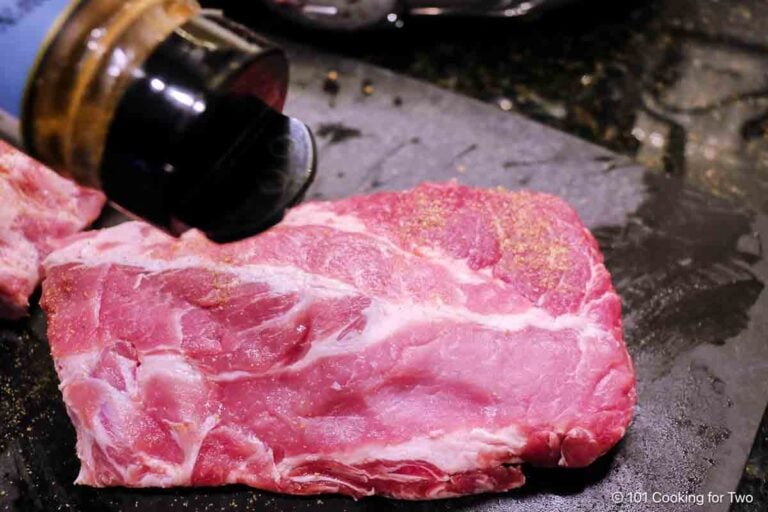 seasoning half slab of baby back ribs.