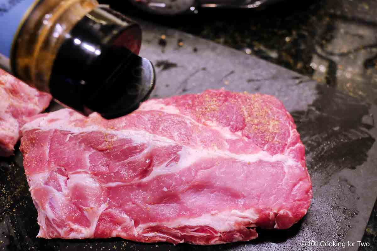 seasoning half slab of baby back ribs.