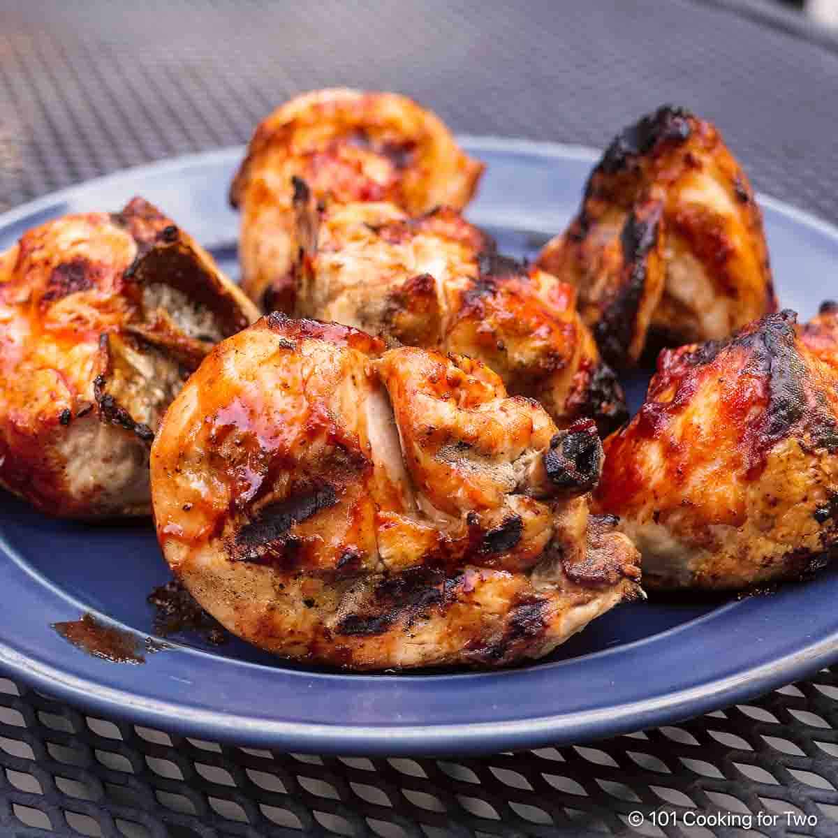 Simple Grilled BBQ Split Chicken Breast from 101 Cooking for Two BBQ split bone-in chicken breasts on a plate.