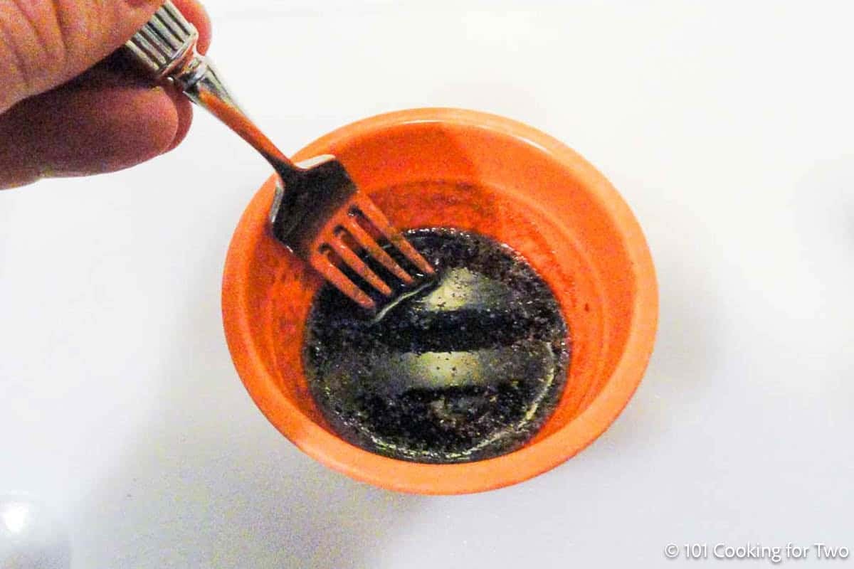 Mixing marinade in a small bowl.