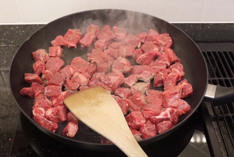 Browning cubes of chuck roast in a skilletBrowning cubes of chuck roast in a skillet