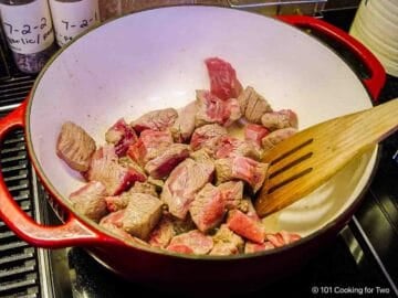 Browning beef in a Dutch oven.