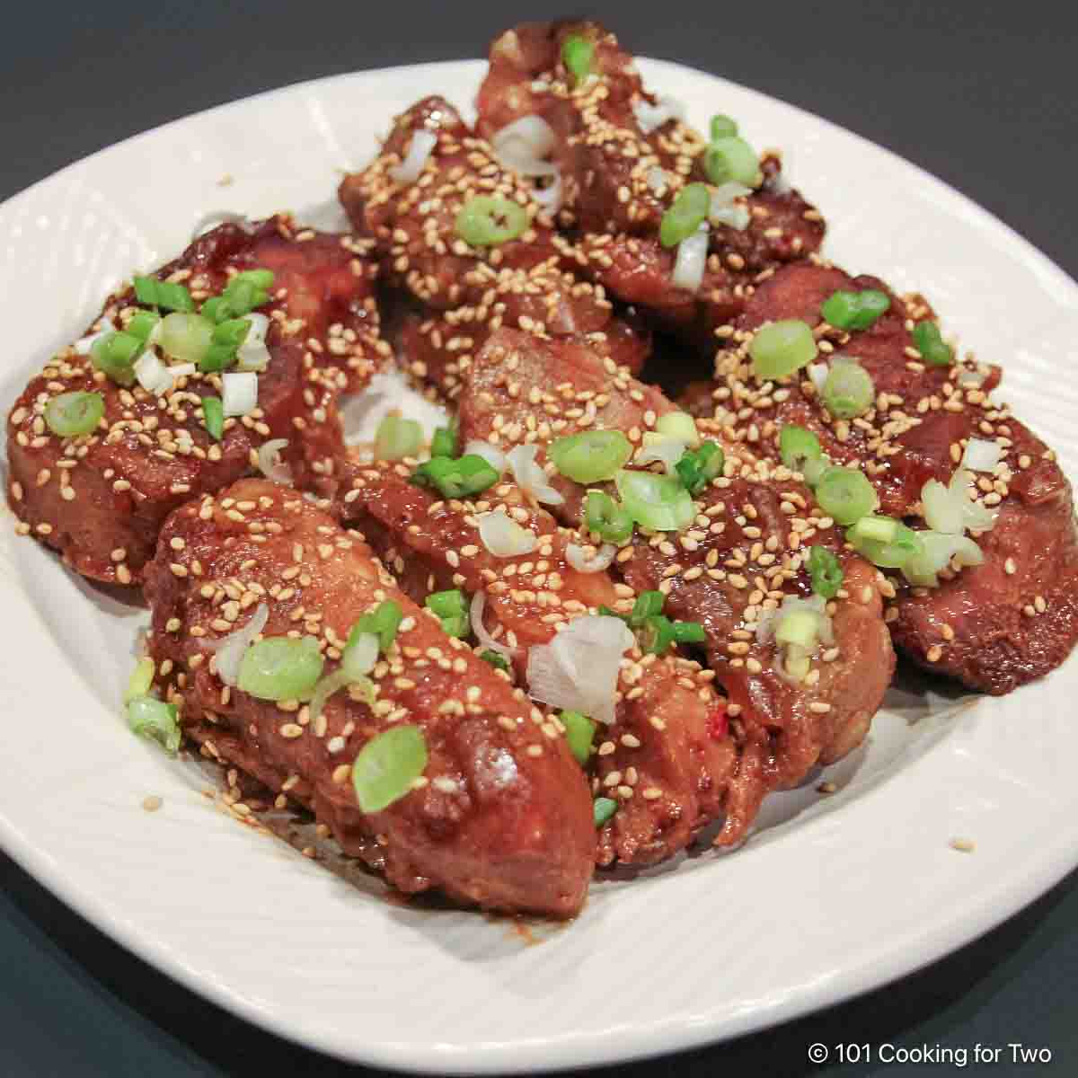 Sesame Pork Ribs in the Crock Pot Plate full of sesame boneless ribs.