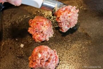 Using an ice cream scoop to make meatballs.