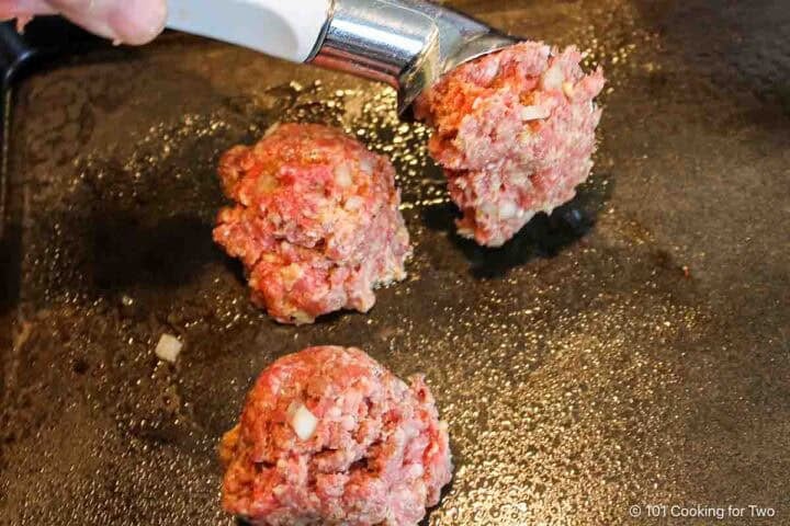 Using an ice cream scoop to make meatballs.