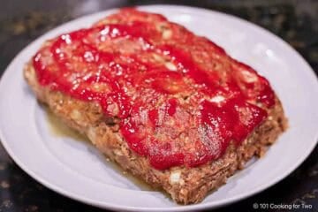 Whole meatloaf on a gray plate.