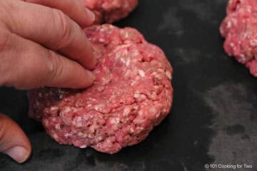 Forming burger patties with a dimple.