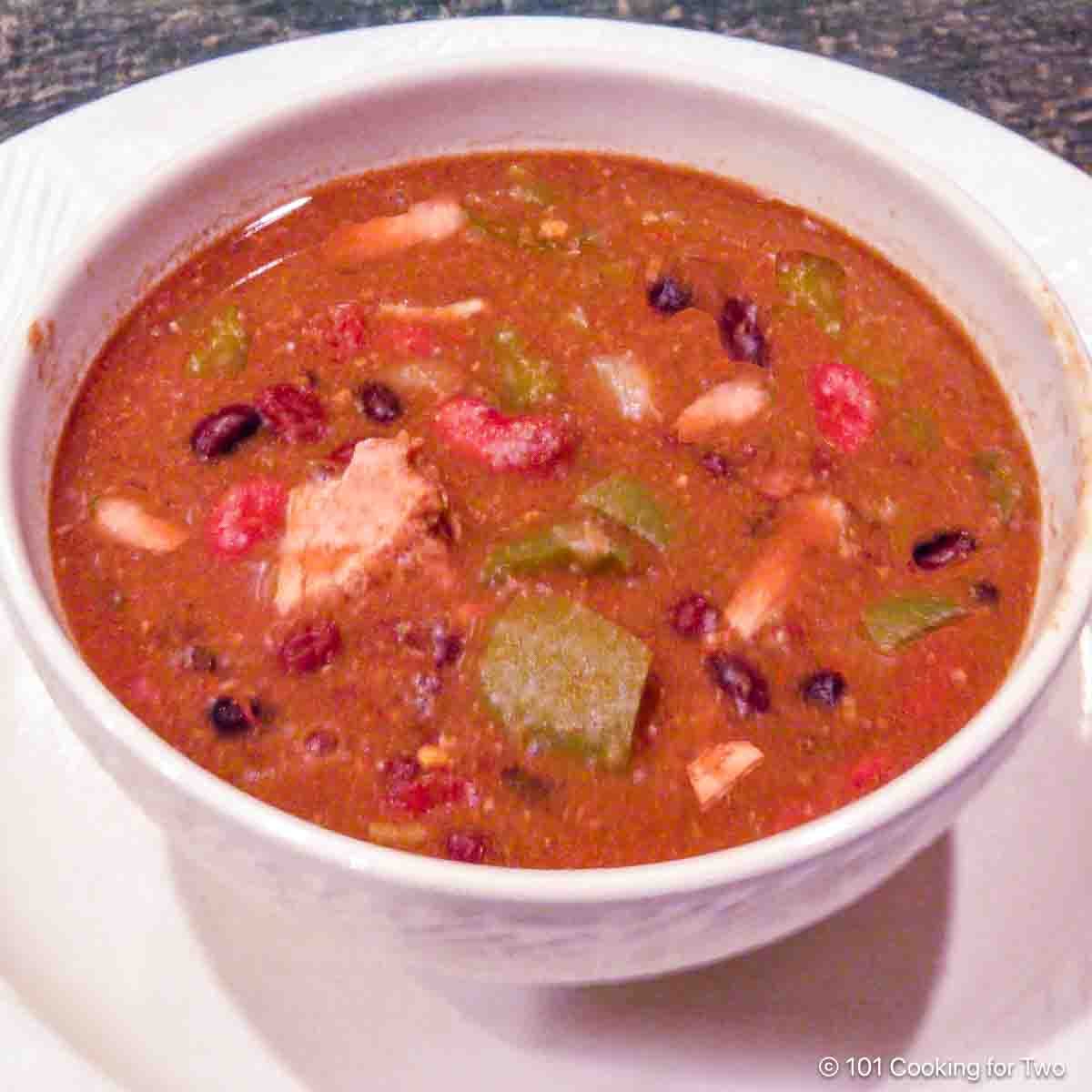 Pork chili in a white bowl.