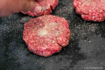 Seasoning burgers.