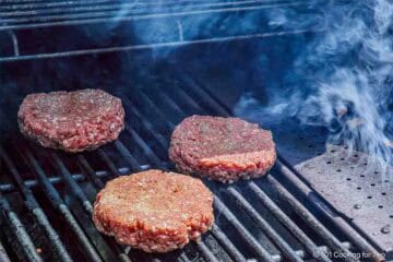 Smoking burgers on the grill.