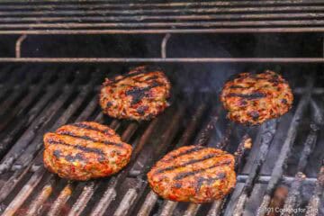 Cooked smoked burgers on the grill.