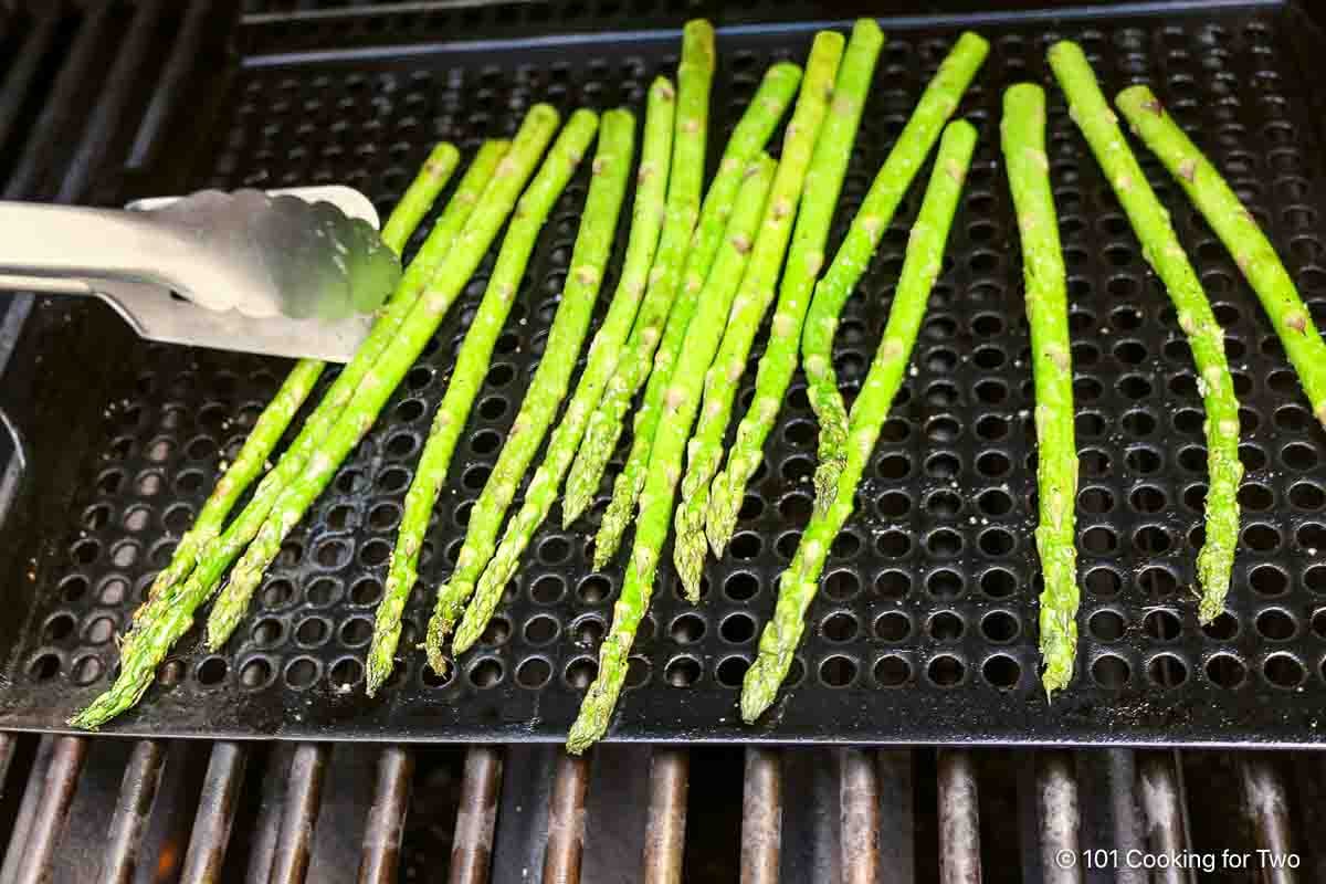 Cooking asparagus on a grill pan.