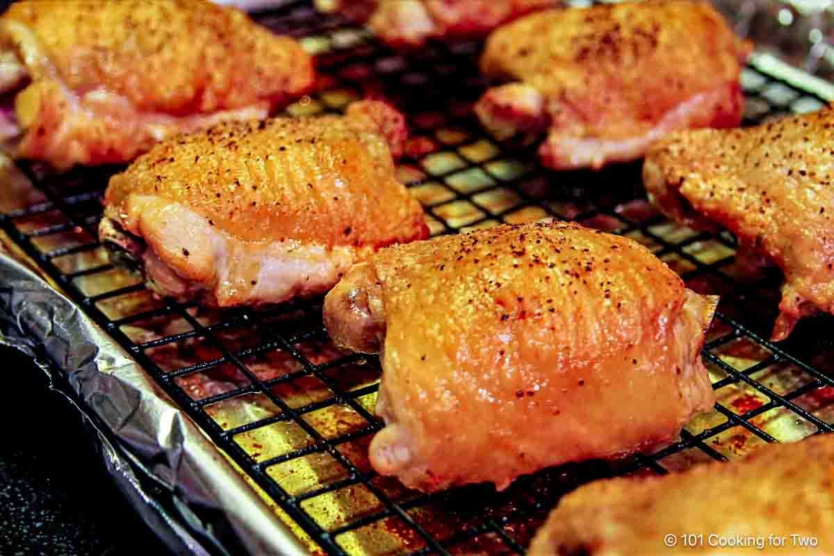 Golden brown cooked thighs on a tray.