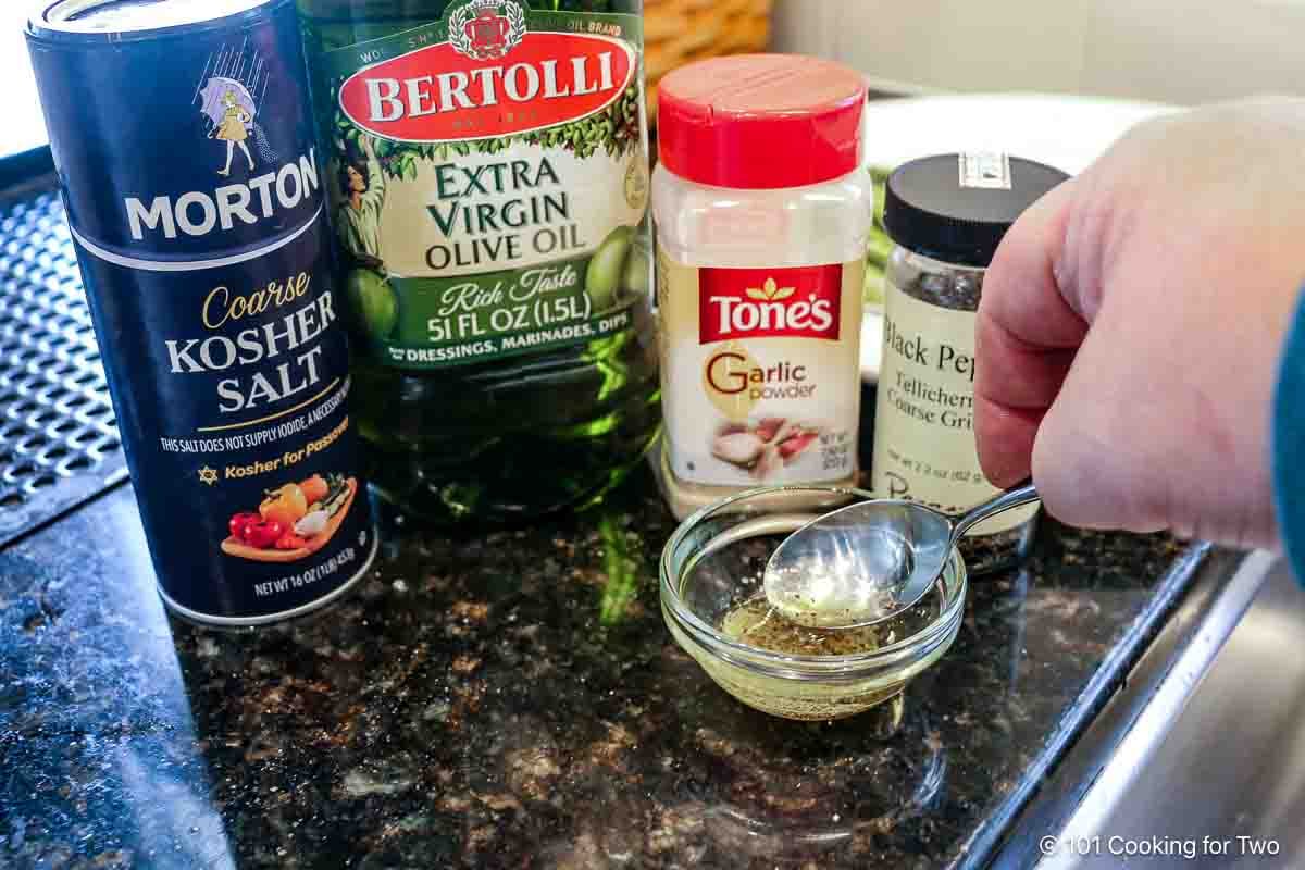 Mixing olive oli and spices.