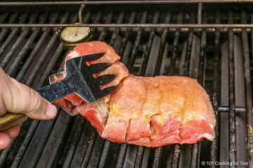Placing boneless ribs on the grill.