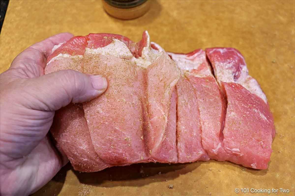 Seasoning with rub into the cuts.