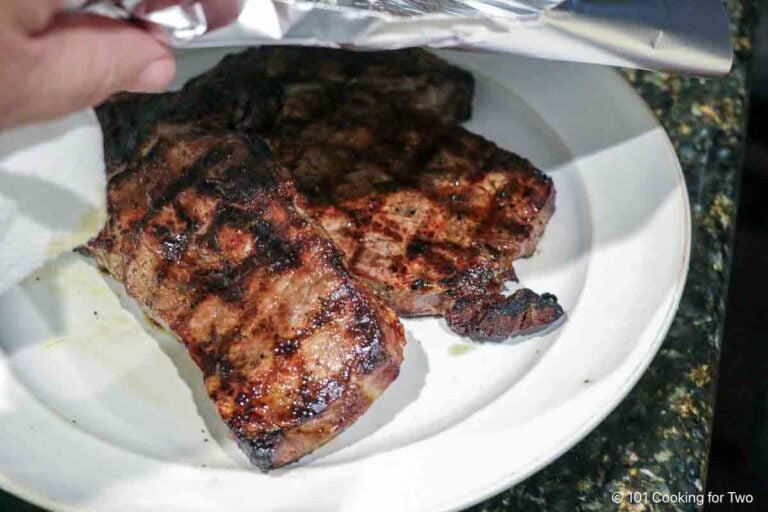 Tenting steaks with foil.