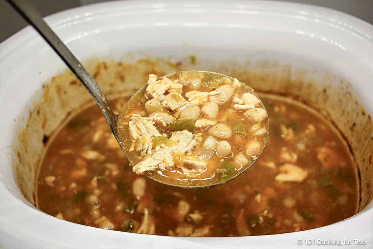 Salsa verde chili in a ladle.