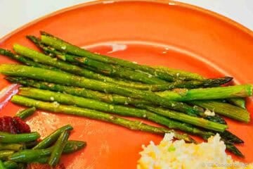 A serving of roasted asparagus on a plate.