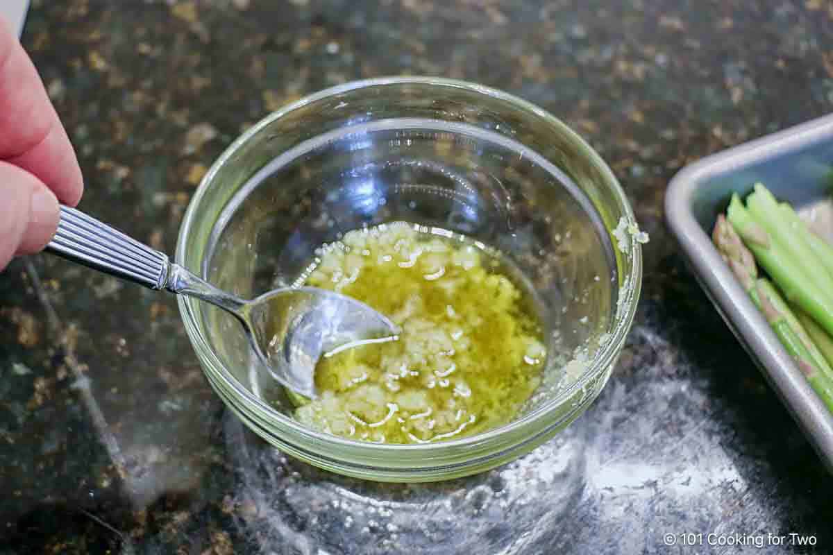 Mixing garlic into the olive oil.