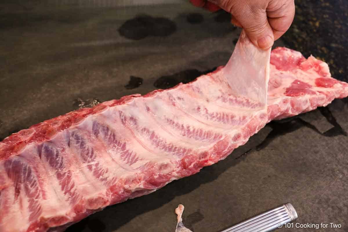 Removing the inner membrane on a rack of ribs.