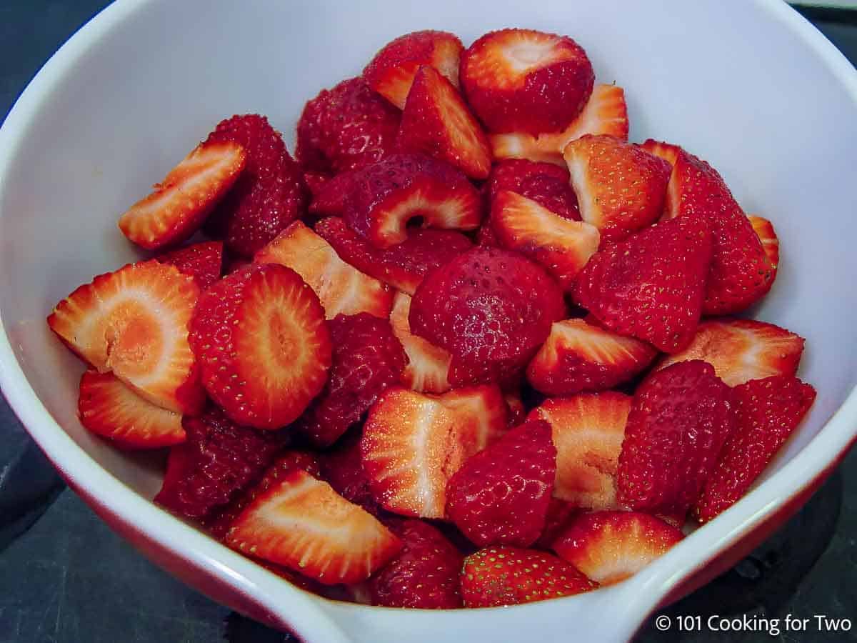 Trimmed strawberries in a bowl.